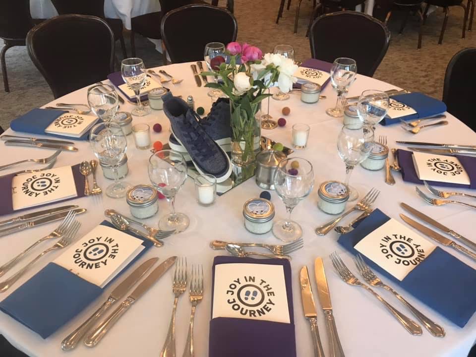 A table set with silverware and place settings.