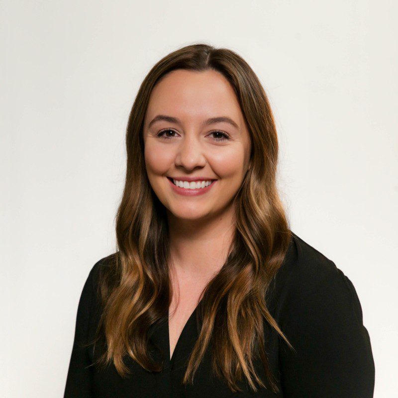 A woman with long hair and wearing black shirt.