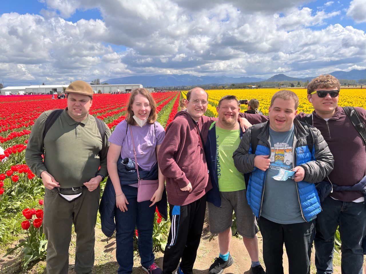 A group of people standing in front of a field.