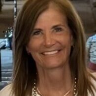 A woman with long hair and a smile.